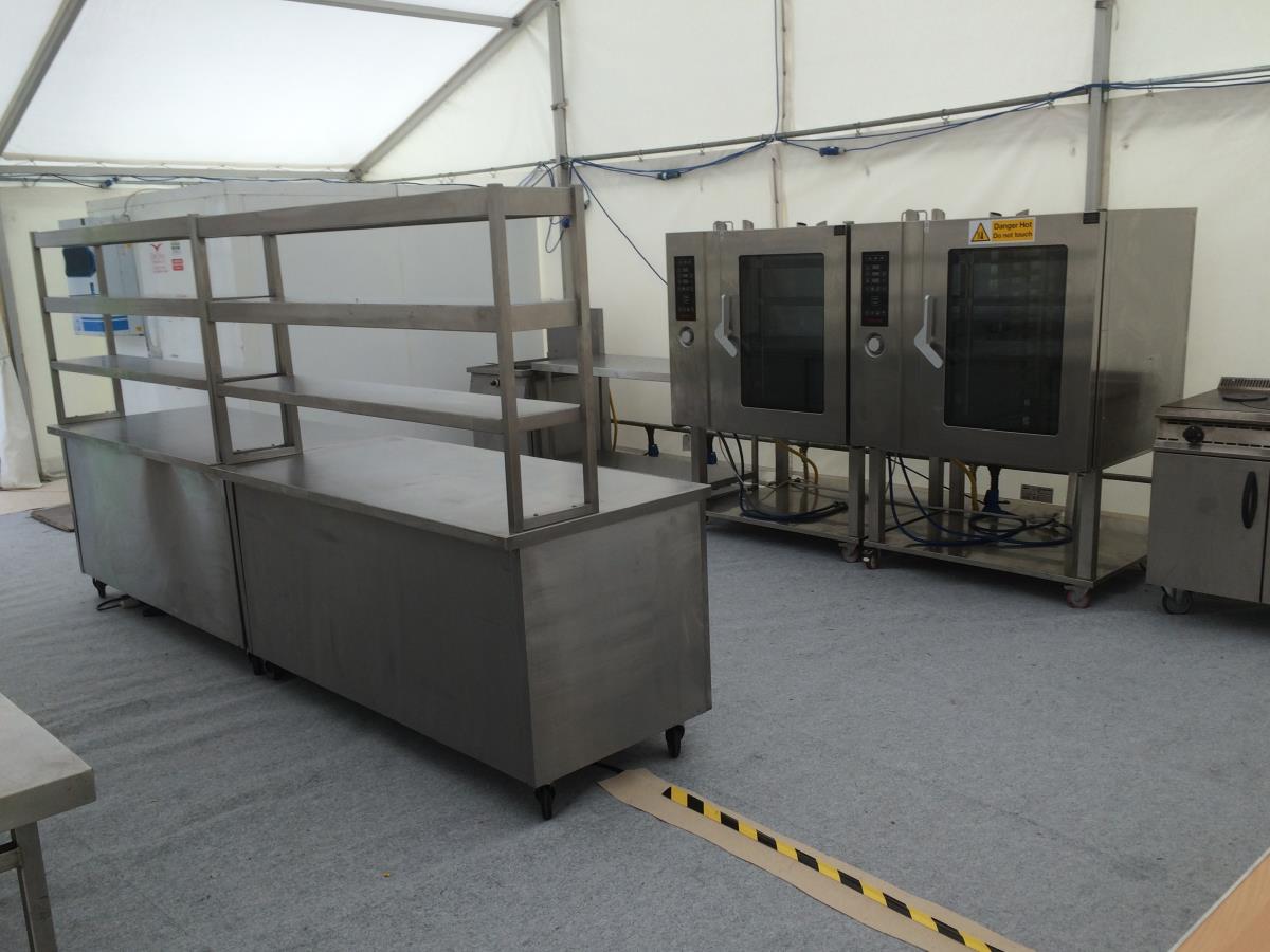 A fully functioning temporary kitchen with a cold room, prep tables, production and servery hot cupboards and gantries.